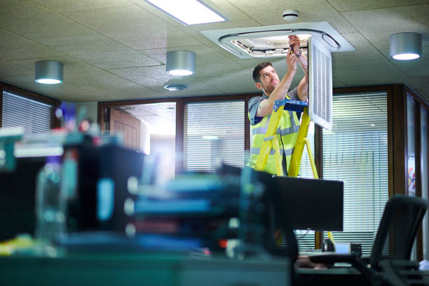 air con maintenance engineer in empty office floor